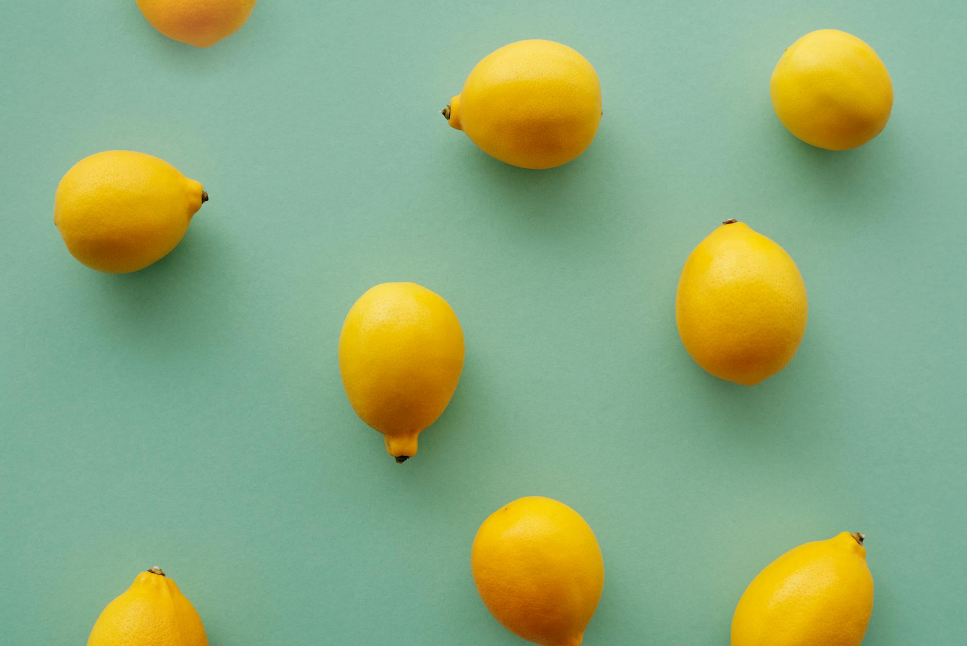 Bright yellow lemons on a pastel background, symbolizing the fresh approach to pleasure after hormonal changes