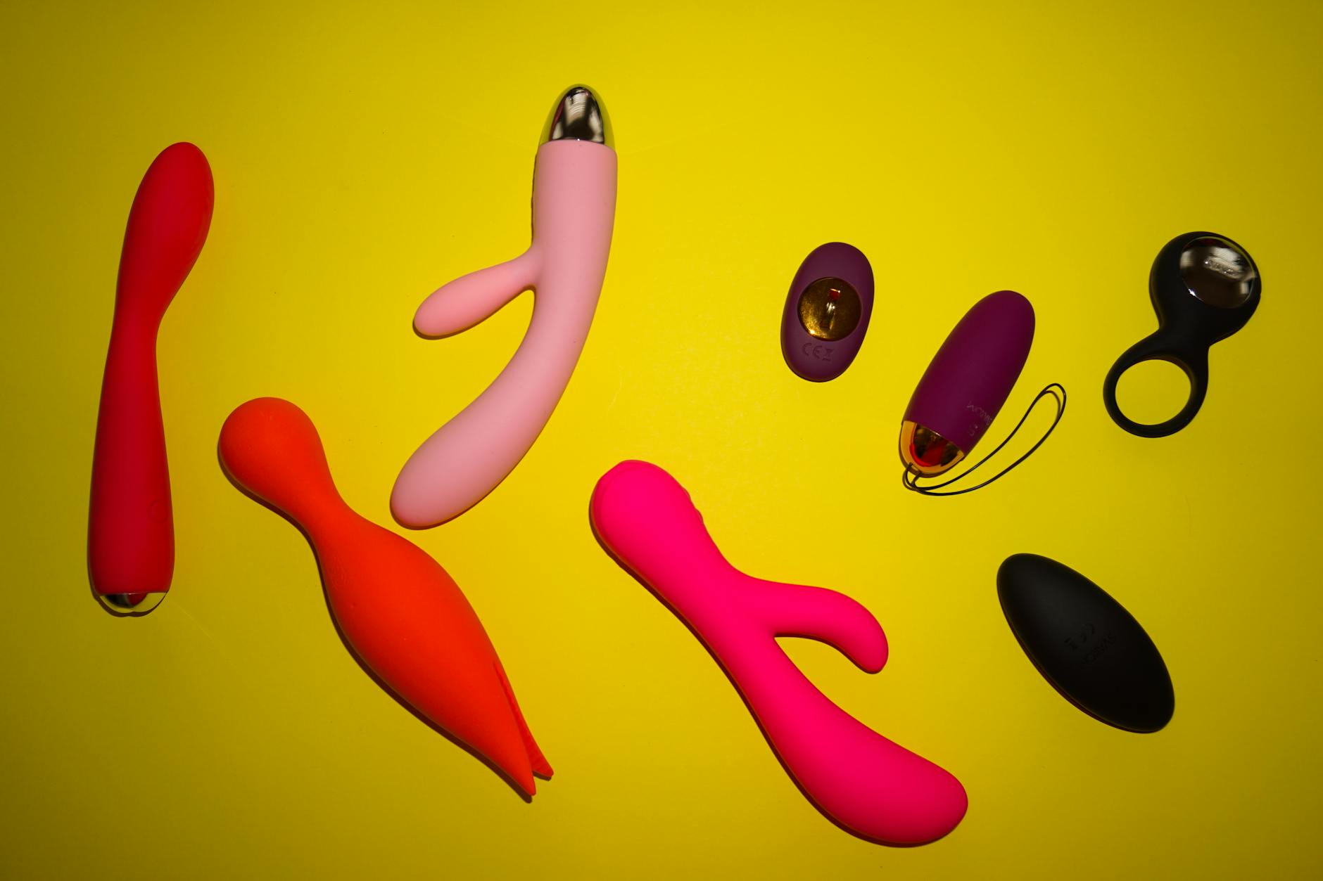 A hand holding a blue silicone vibrator against a purple background, symbolizing comfort and personal choice in partnered intimacy